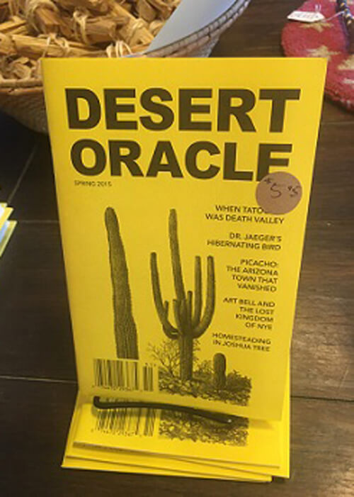 Book cover of "Desert Oracle" by Ken Layne - yellow cover with cactus drawing underneath title.