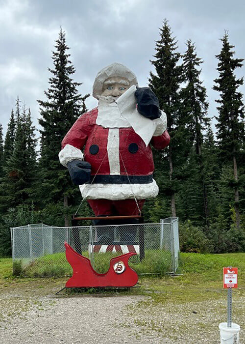 Giant Santa Claus statue with cloudy sky above