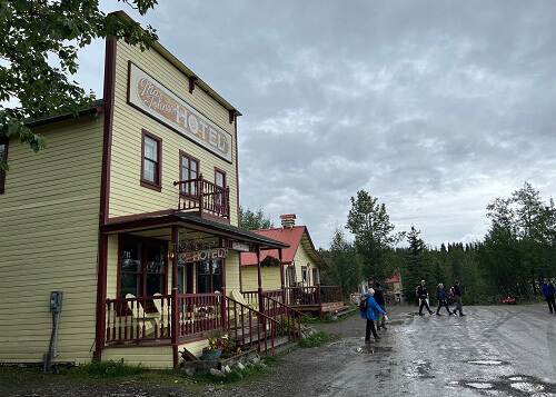 Looking down muddy street with Ma Johnson's motel on left