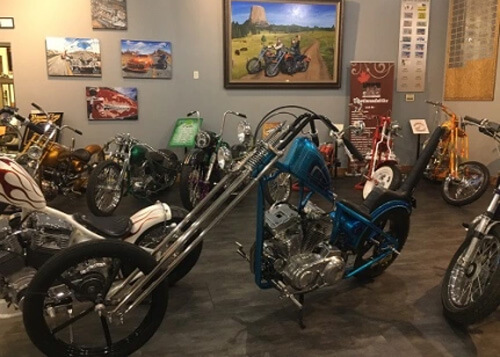 Blue painted chopper motorcycle in the Motorcycle Hall of Fame, other motorcycles in the background.