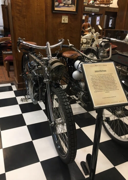 1910 motorcycle in the Motorcycle Hall of Fame, with sign saying "1910."