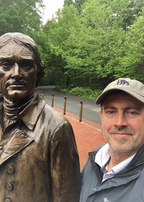 Mark Loftin on the right with statue of Thomas Jefferson on left.