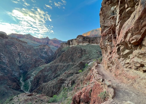 Trail hugging side of cliff through Grand Canyon, valley down below